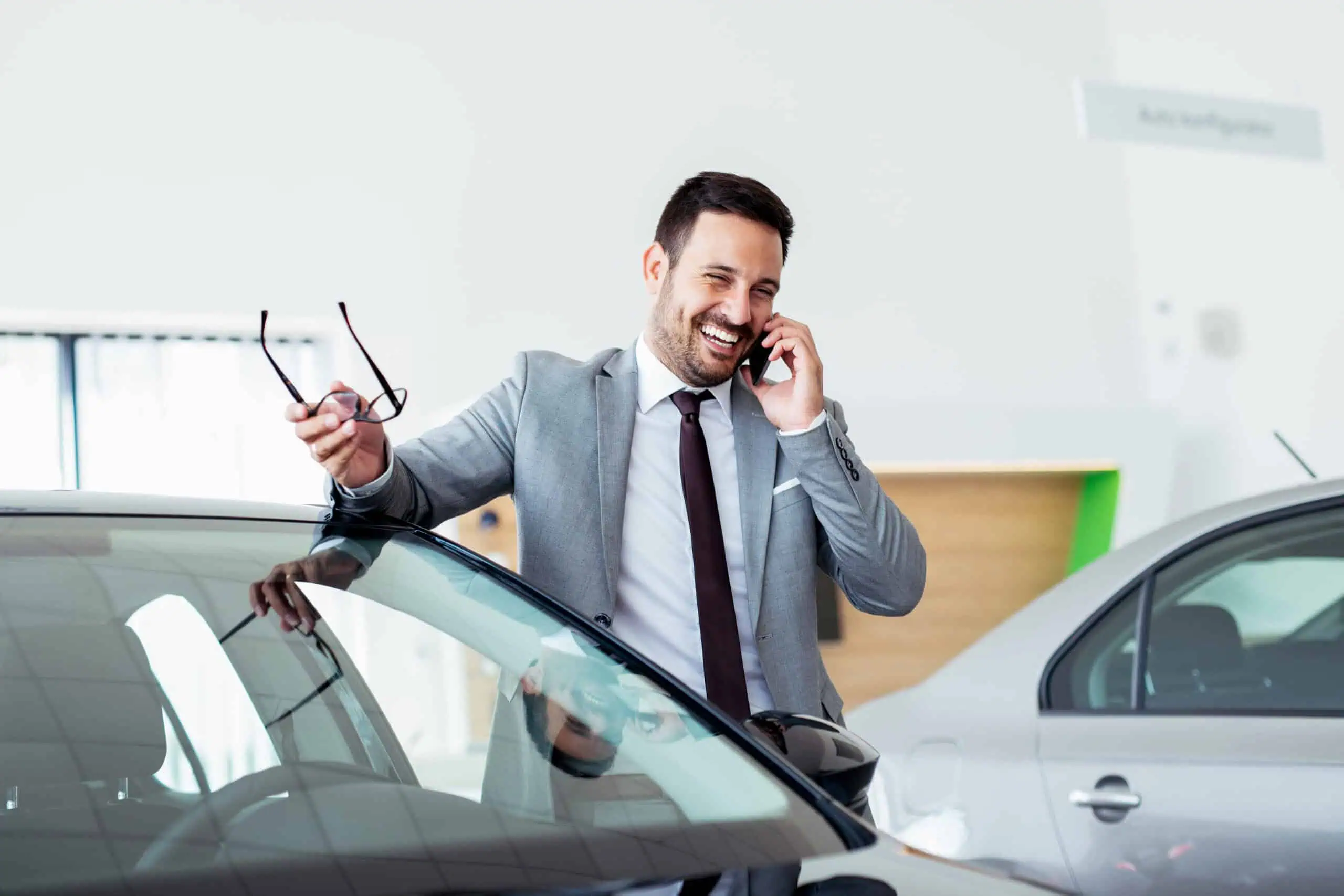 Man in Dealership on Phone